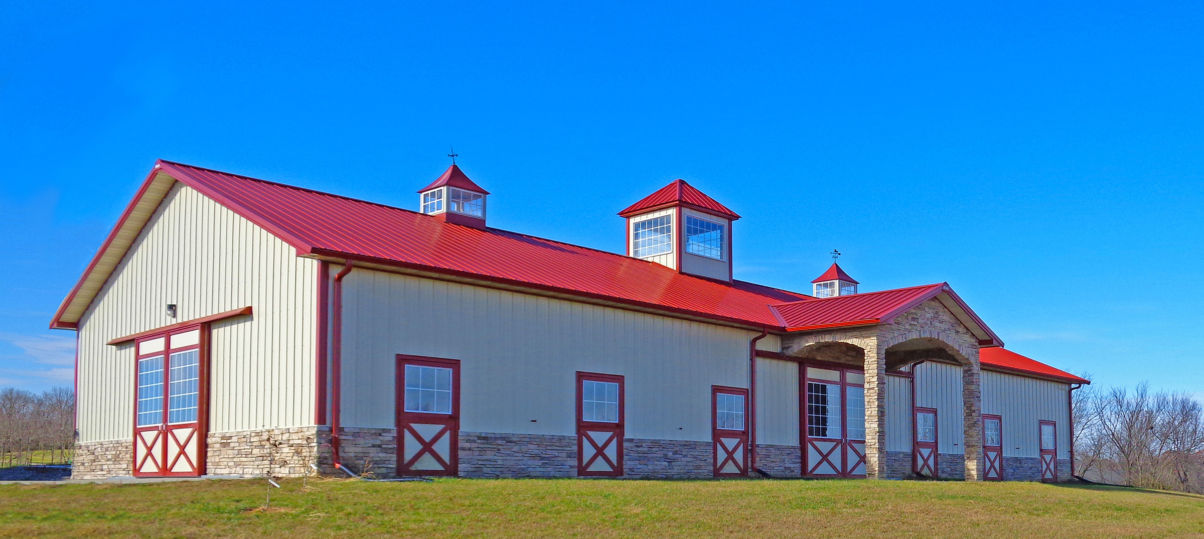 red and light gray postframe equine building