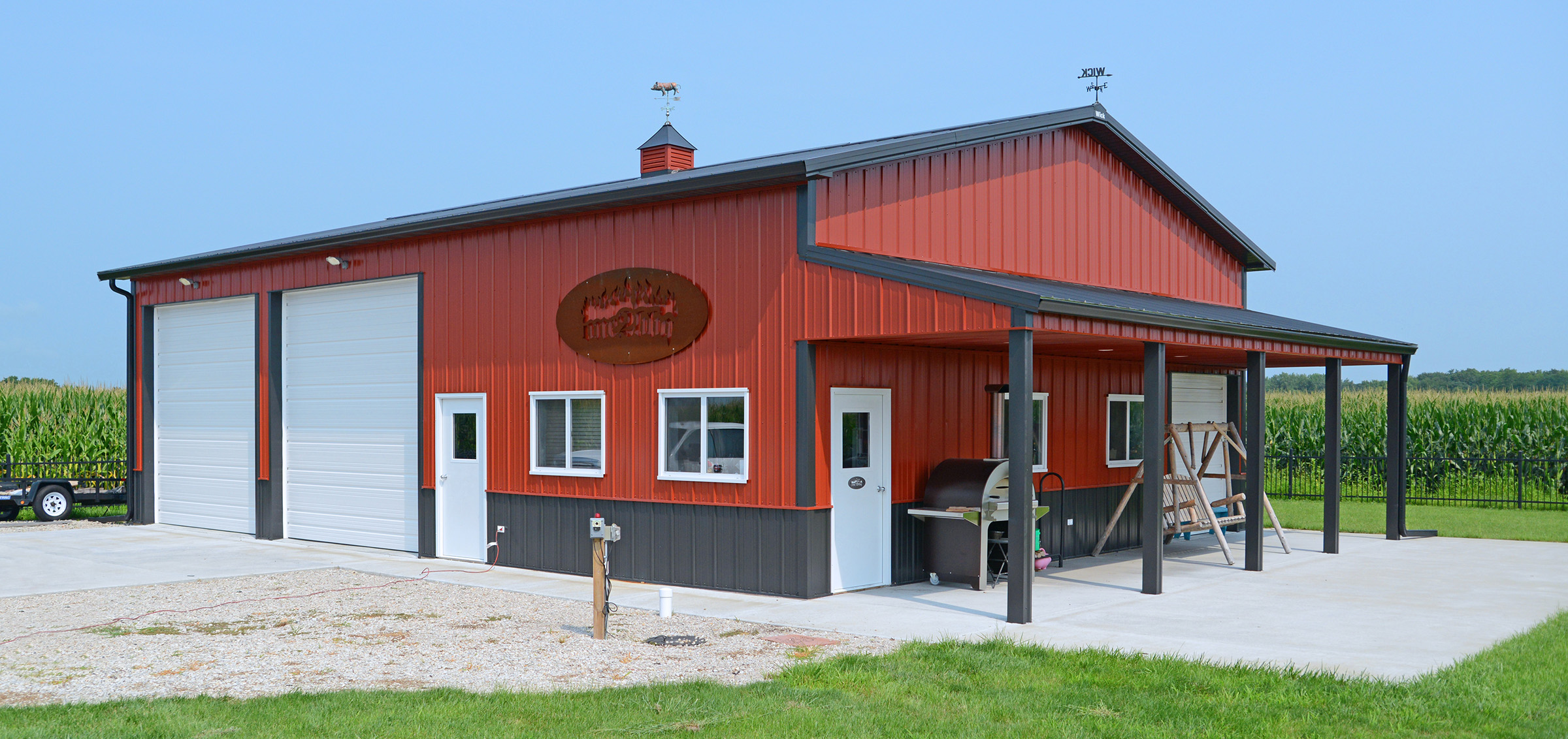 red with gray trim suburban postframe building